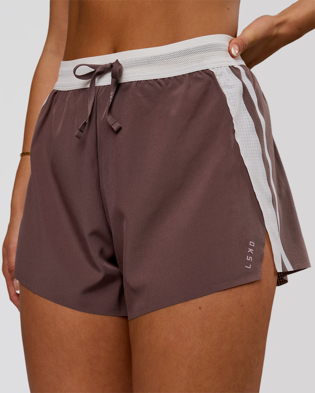Woman wearing Accelerate 3" Force High-Rise Running Short - Cocoa Powder | Model:Bianca | Size:S - view 1