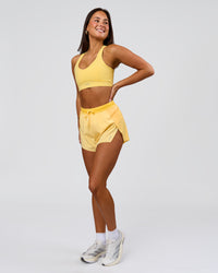 Woman wearing Accelerate 3" High-Rise Running Short - Sunbeam-Lemon | Model:Bianca | Size:S | Thumbnail Index: 2