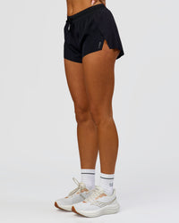 Woman wearing Accelerate 3" Mid-Rise Running Short - Black | Model:Bianca | Size:S | Thumbnail Index: 2