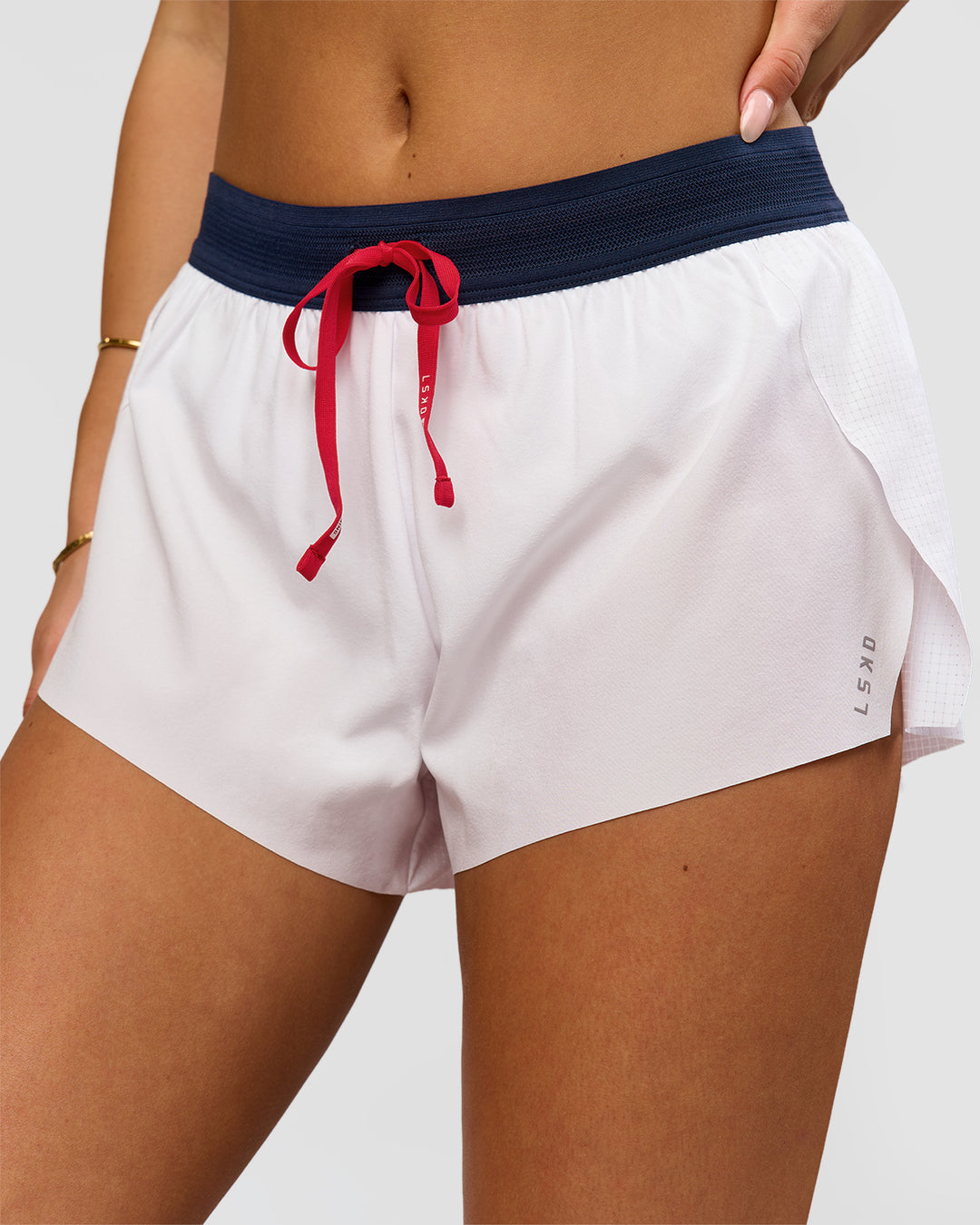 Woman wearing Accelerate 3" Mid-Rise Running Short - White-Future Navy | Model:Bianca | Size:S - view 2