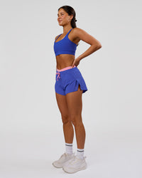 Woman wearing Accelerate Synergy 3" Running Short Short - Power Cobalt-Pink Rose | Model:Bianca | Size:S | Thumbnail Index: 5
