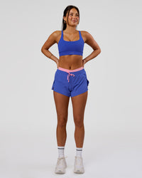 Woman wearing Accelerate Synergy 3" Running Short Short - Power Cobalt-Pink Rose | Model:Bianca | Size:S | Thumbnail Index: 10