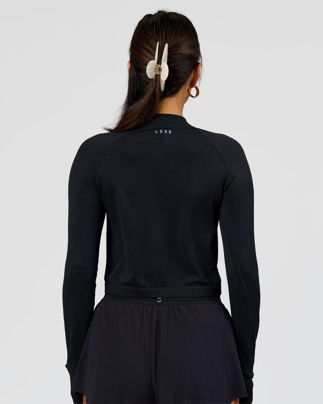 Woman wearing AeroFLX+ Long Sleeve Skimmer Half Zip - Black Marl | Model:Bianca | Size:S - view 2