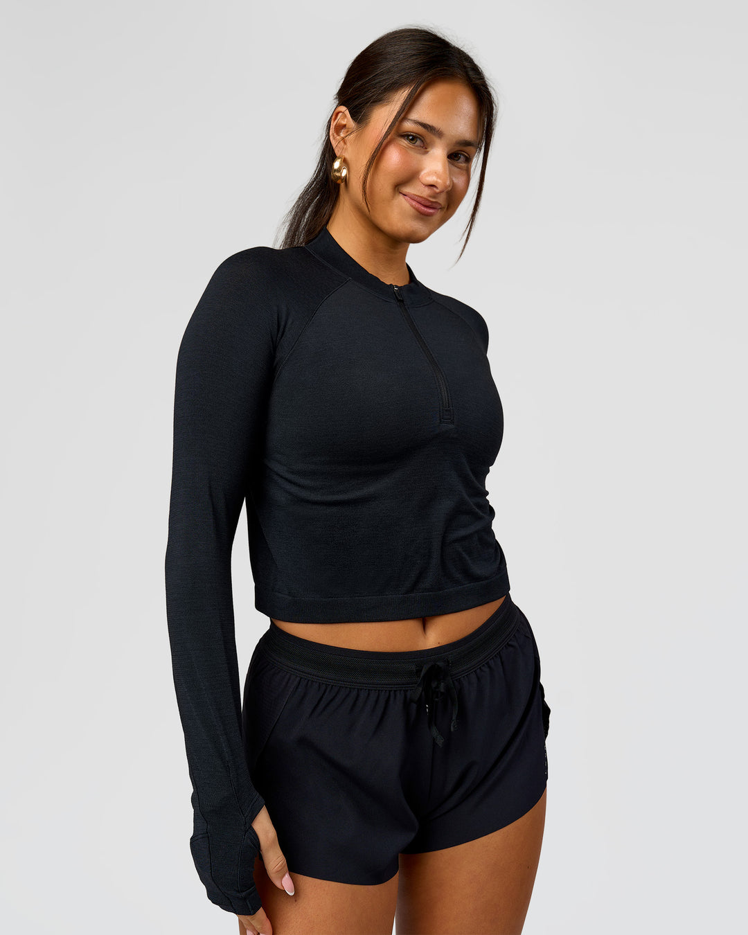 Woman wearing AeroFLX+ Long Sleeve Skimmer Half Zip - Black Marl | Model:Bianca | Size:S - view 5