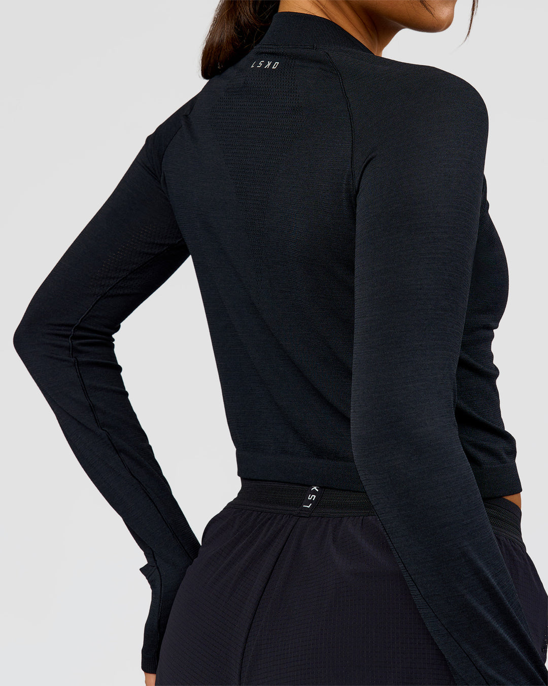 Woman wearing AeroFLX+ Long Sleeve Skimmer Half Zip - Black Marl | Model:Bianca | Size:S - view 6
