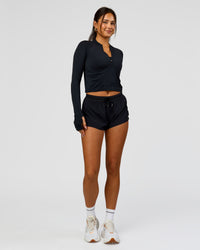 Woman wearing AeroFLX+ Long Sleeve Skimmer Half Zip - Black Marl | Model:Bianca | Size:S | Thumbnail Index: 8