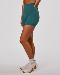 Woman wearing Elixir High-Rise 6” Short - Transformative Teal | Model:Bianca | Size:S | Thumbnail Index: 4
