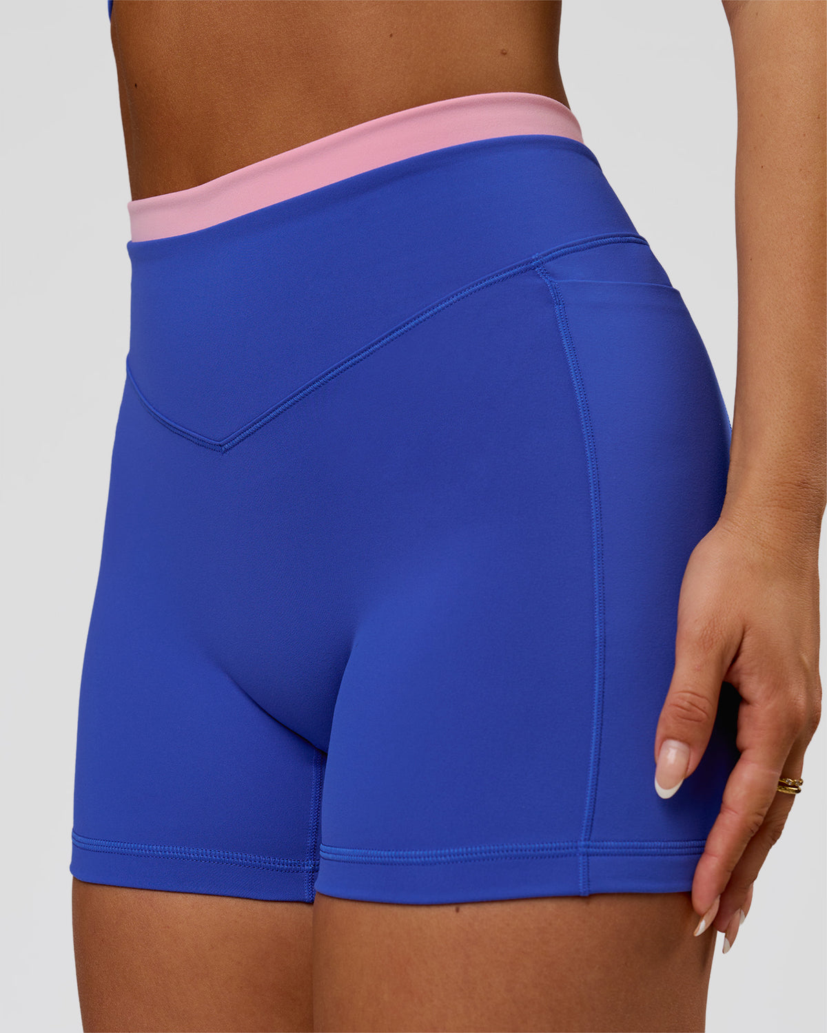 Woman wearing Fusion Contrast V-Waist High-Rise 4" Short Pockets - Power Cobalt-Pink Rose | Model:Bianca | Size:S - view 1