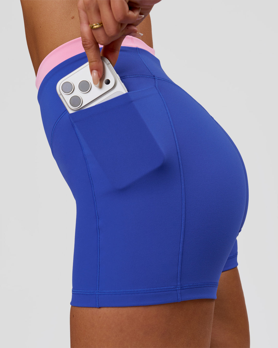Woman wearing Fusion Contrast V-Waist High-Rise 4" Short Pockets - Power Cobalt-Pink Rose | Model:Bianca | Size:S - view 2