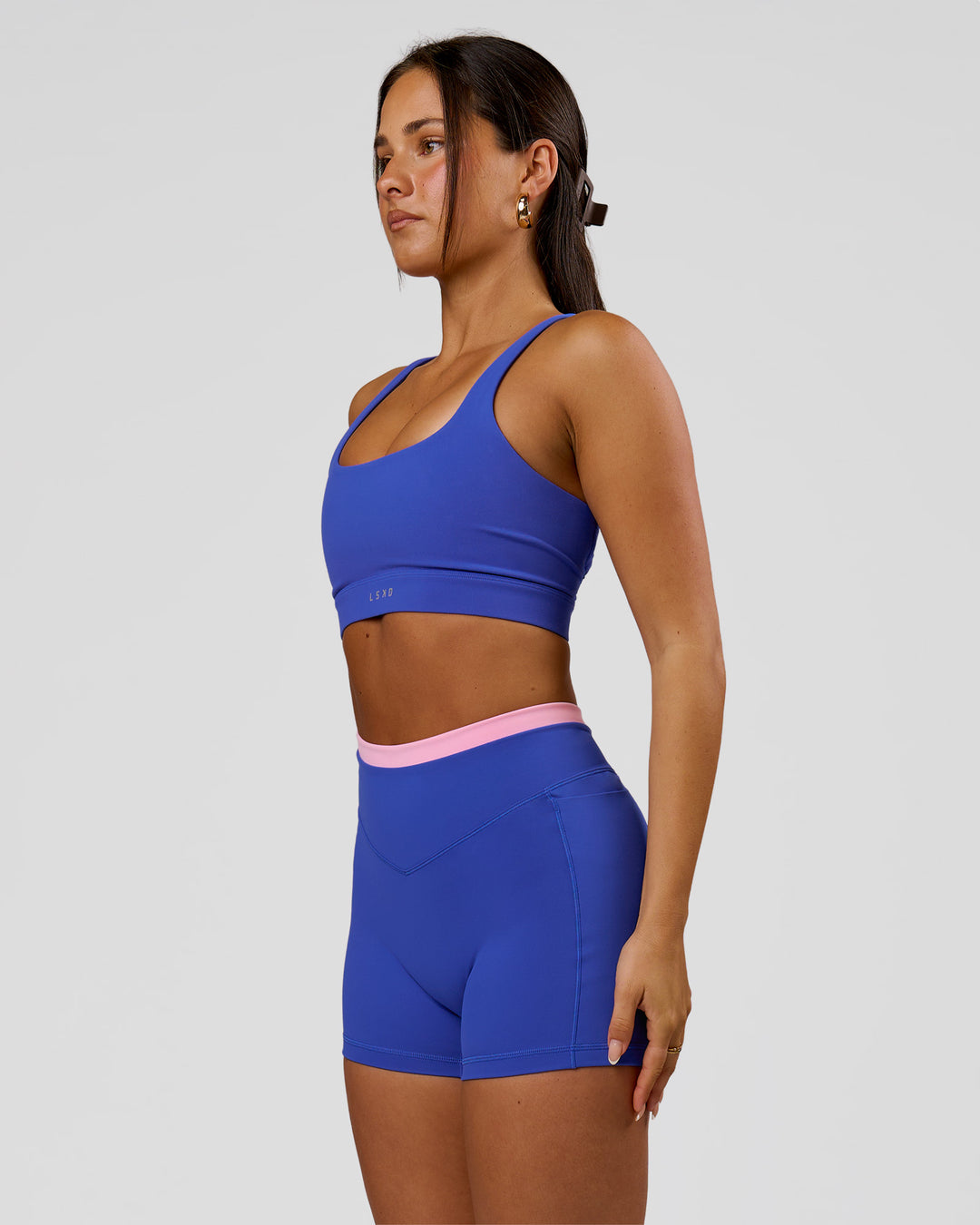 Woman wearing Fusion Contrast V-Waist High-Rise 4" Short Pockets - Power Cobalt-Pink Rose | Model:Bianca | Size:S - view 5