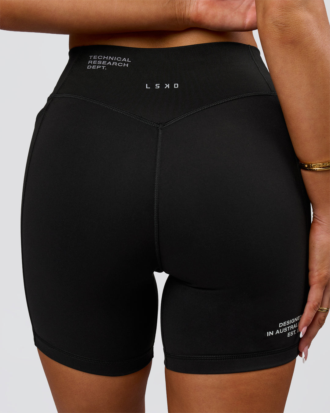 Woman wearing Fusion V-Contour High-Rise 6" Short Pockets - Black-Tech Department | Model:Bianca | Size:S - view 3
