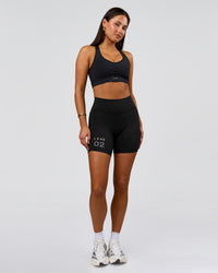 Woman wearing Fusion V-Contour High-Rise 6" Short Pockets - Black-Tech Department | Model:Bianca | Size:S | Thumbnail Index: 1