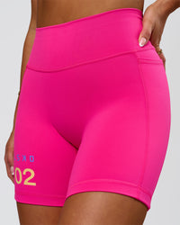 Woman wearing Fusion V-Contour High-Rise 6" Short Pockets - Ultra Pink-Tech Department | Model:Bianca | Size:S | Thumbnail Index: 6