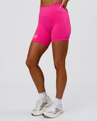 Woman wearing Fusion V-Contour High-Rise 6" Short Pockets - Ultra Pink-Tech Department | Model:Bianca | Size:S | Thumbnail Index: 3