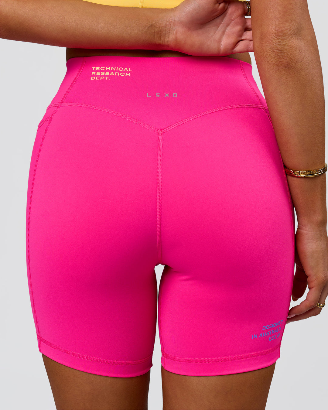 Woman wearing Fusion V-Contour High-Rise 6" Short Pockets - Ultra Pink-Tech Department | Model:Bianca | Size:S - view 10