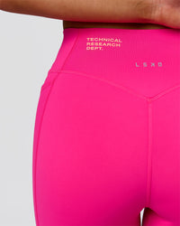 Woman wearing Fusion V-Contour High-Rise 6" Short Pockets - Ultra Pink-Tech Department | Model:Bianca | Size:S | Thumbnail Index: 13