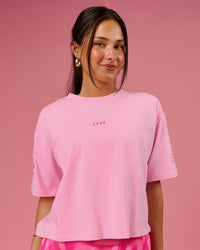 Woman wearing Go-To Heavyweight FLXCotton Graphic Skimmer Tee - Pink Rose-We Rise | Model:Bianca | Size:S | Thumbnail Index: 0