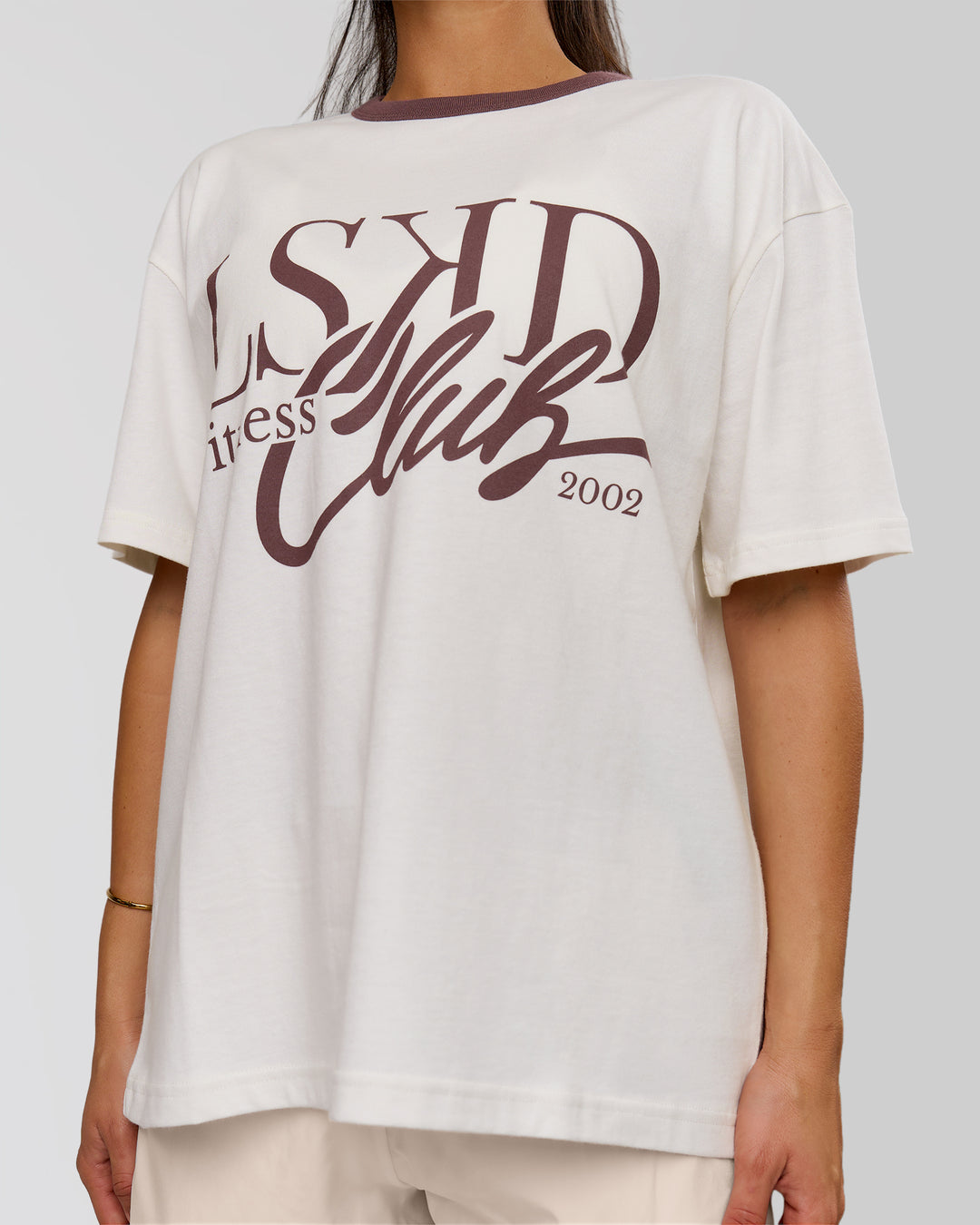 Woman wearing LSKD Fitness Club Heavyweight Oversized Tee - Off White-Cocoa Powder | Model:Bianca | Size:S - view 2