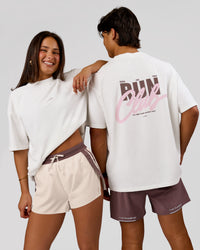 Woman wearing Run Club Unisex Oversized Heavyweight FLXCotton Tee - Off White | Model:Bianca | Size:S | Thumbnail Index: 0