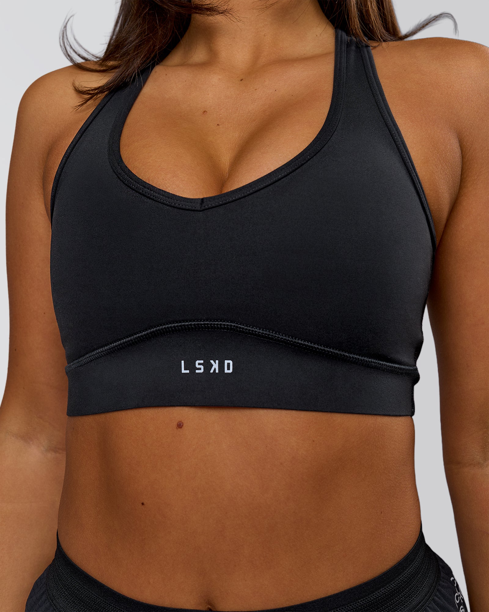 Woman wearing Stamina Amplify Sports Bra - Black | Model:Bianca | Size:S