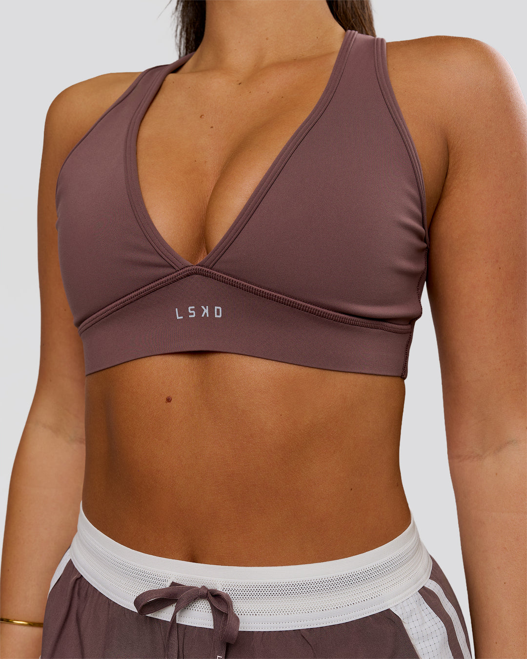 Woman wearing Stamina Sports Bra - Cocoa Powder | Model:Bianca | Size:S - view 1
