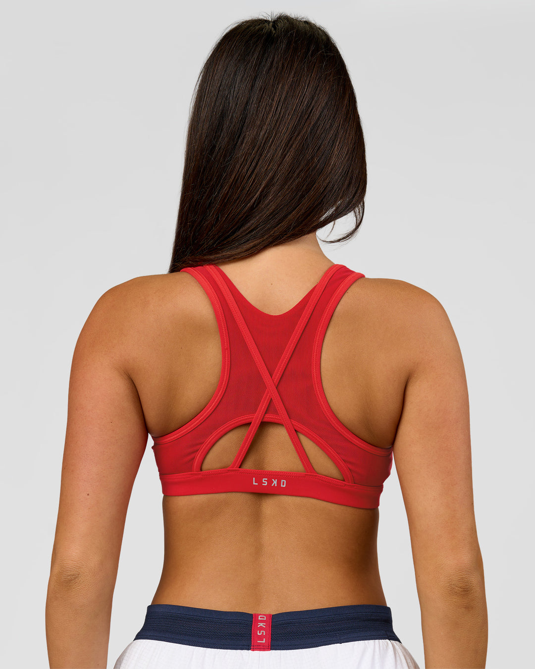Woman wearing Unstoppable Racerback Sports Bra - Scarlet | Model:Bianca | Size:S - view 3