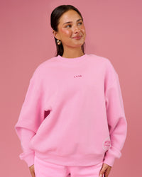 Woman wearing We Rise Oversized Sweater - Pink Rose-We Rise | Model:Bianca | Size:S | Thumbnail Index: 0