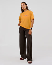 Woman wearing VS6 1% Better Fathers Day FLXCotton Oversized Tee - Warm Apricot | Model:Jess | Size:S | Thumbnail Index: 5