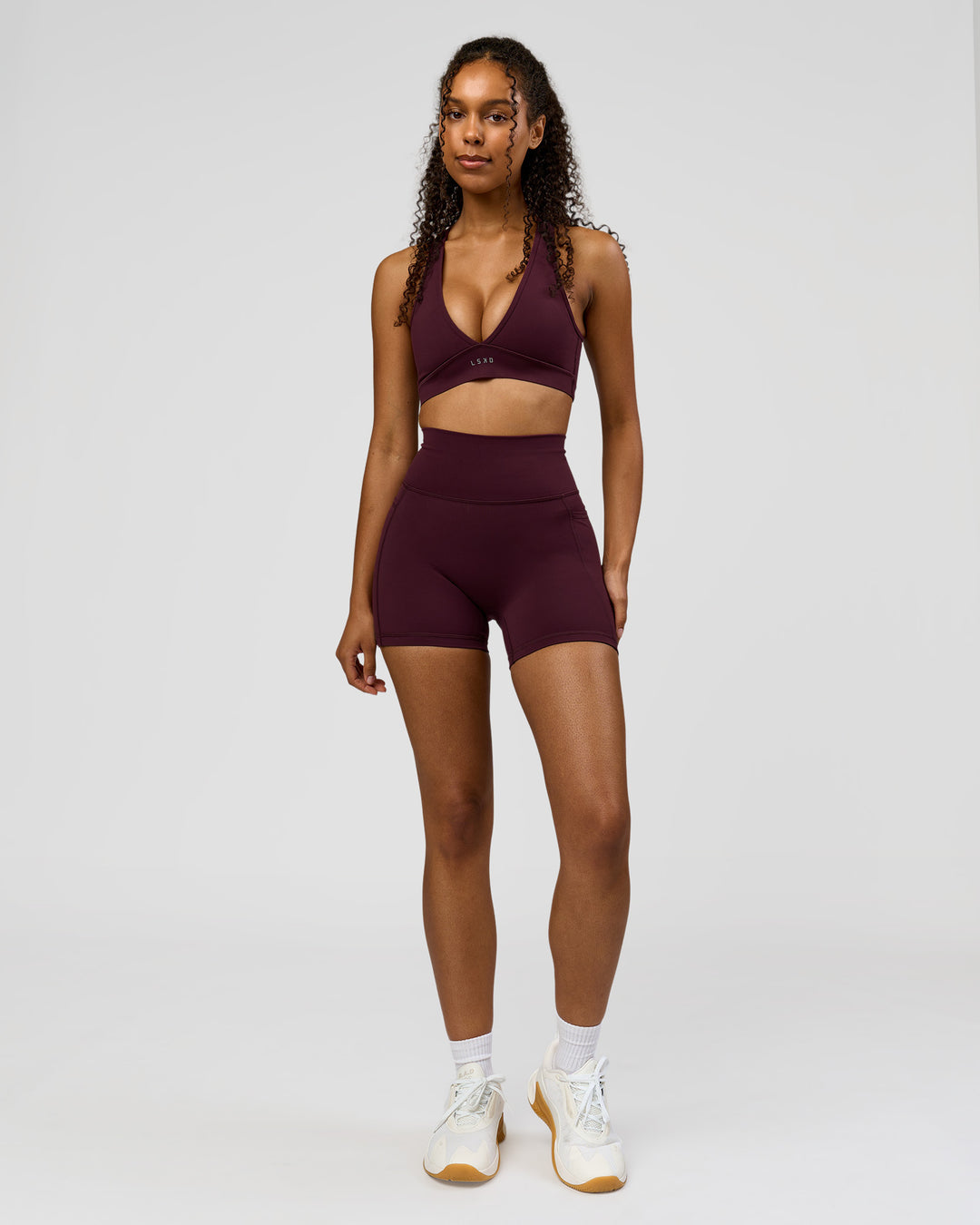 Woman wearing Fusion Ultra High-Rise 4" Short Pockets - Cherry Lacquer | Model:Jordan | Size:S - view 2