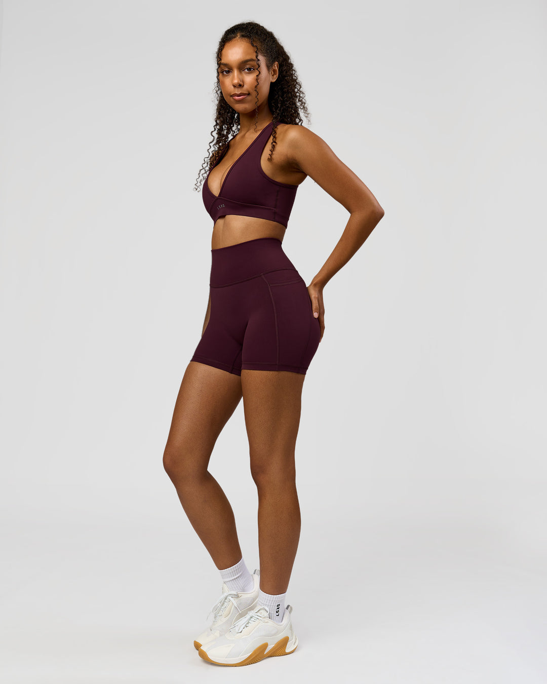 Woman wearing Fusion Ultra High-Rise 4" Short Pockets - Cherry Lacquer | Model:Jordan | Size:S - view 3