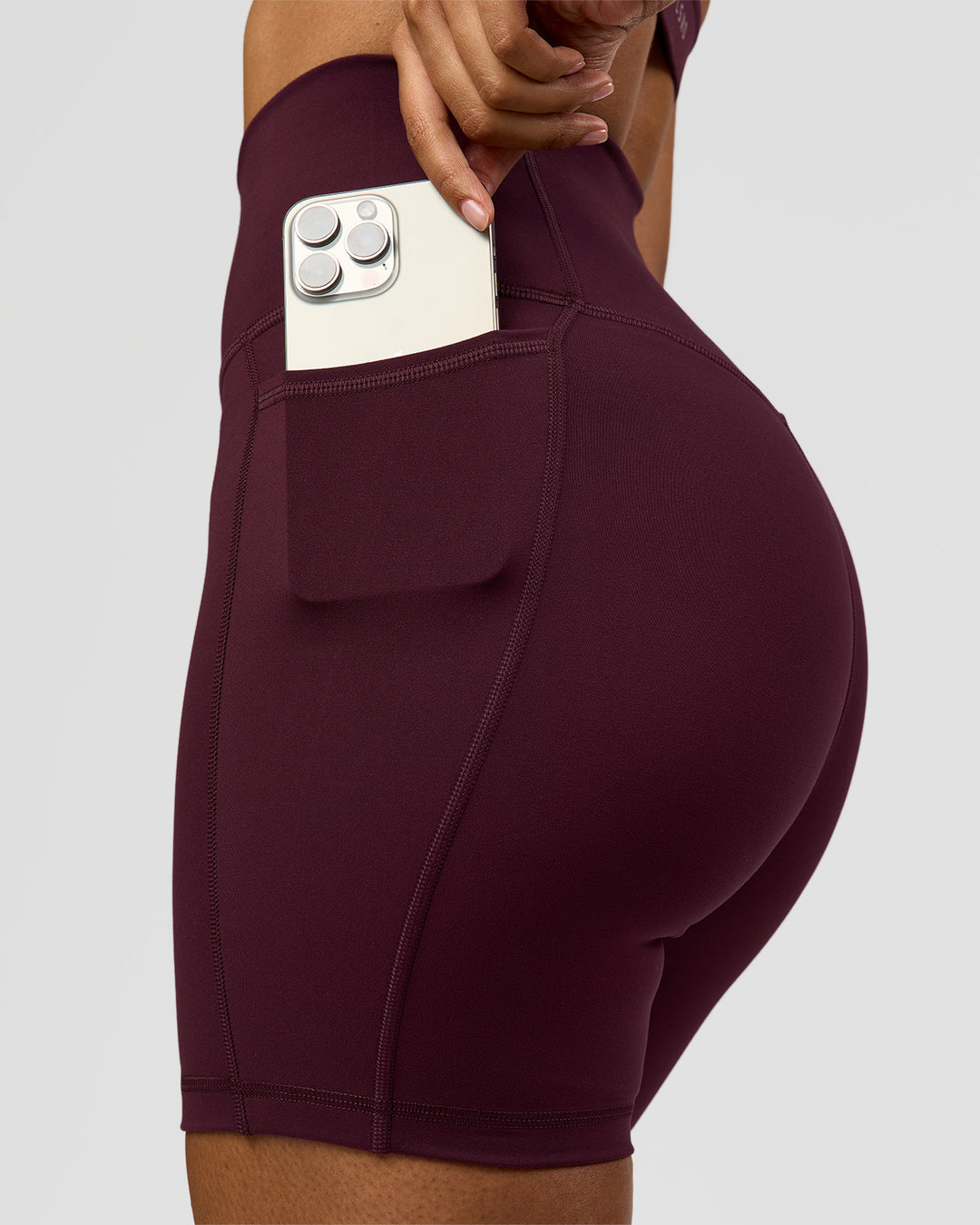 Woman wearing Fusion Ultra High-Rise 6" Short Pockets - Cherry Lacquer | Model:Jordan | Size:S - view 1