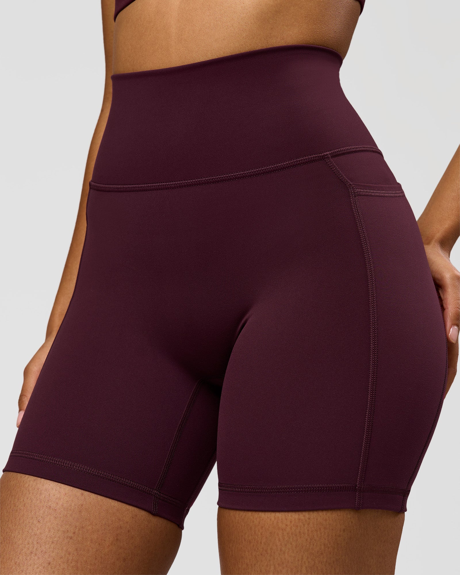 Woman wearing Fusion Ultra High-Rise 6" Short Pockets - Cherry Lacquer | Model:Jordan | Size:S