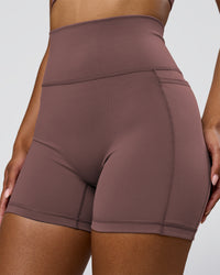 Woman wearing Fusion V-Contour Ultra High-Rise 4" Short Pockets - Cocoa Powder | Model:Jordan | Size:S | Thumbnail Index: 1