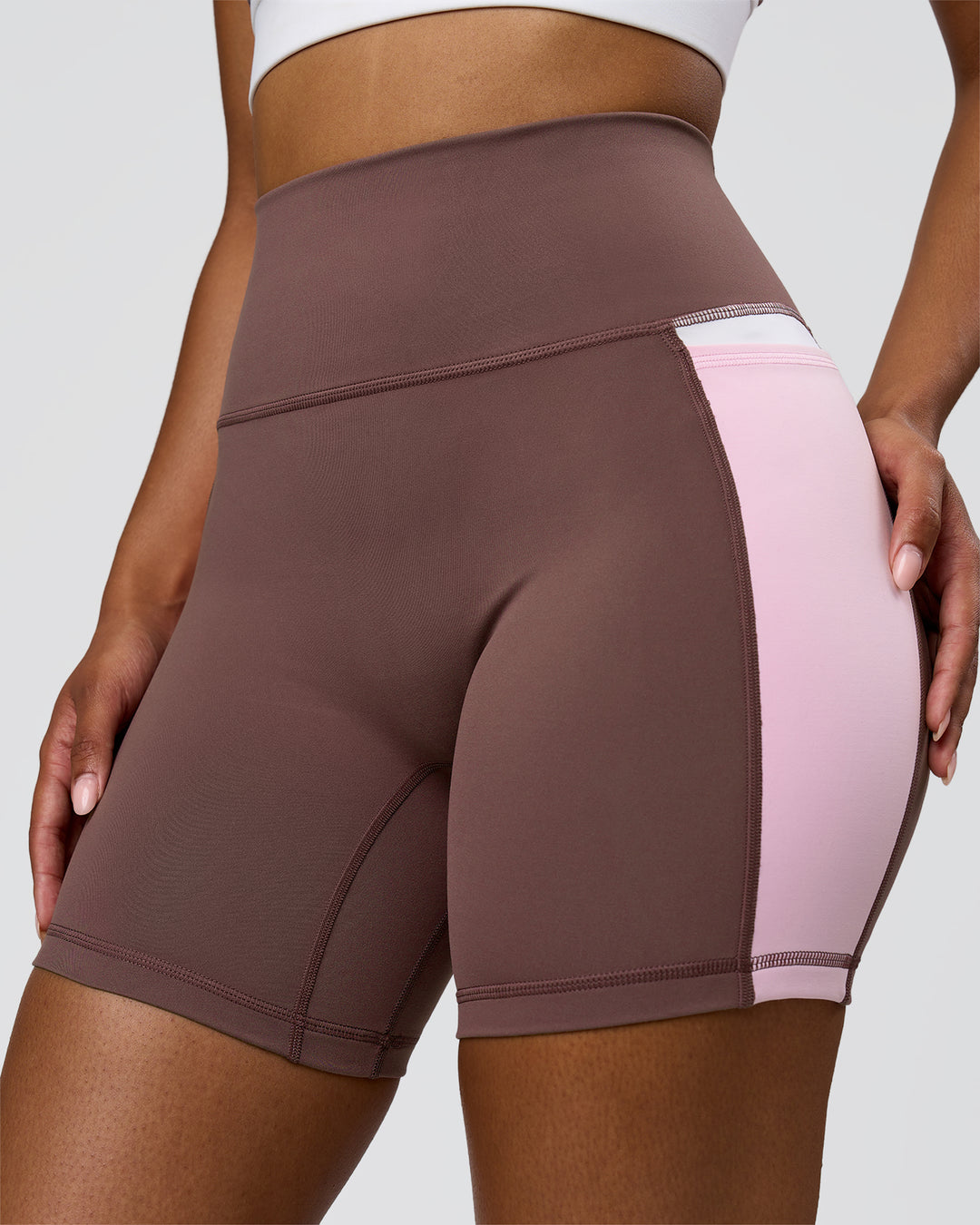 Woman wearing Fusion V-Contour Ultra High-Rise 4" Short Pockets - Cocoa Powder-Marshmallow-White | Model:Jordan | Size:S - view 3