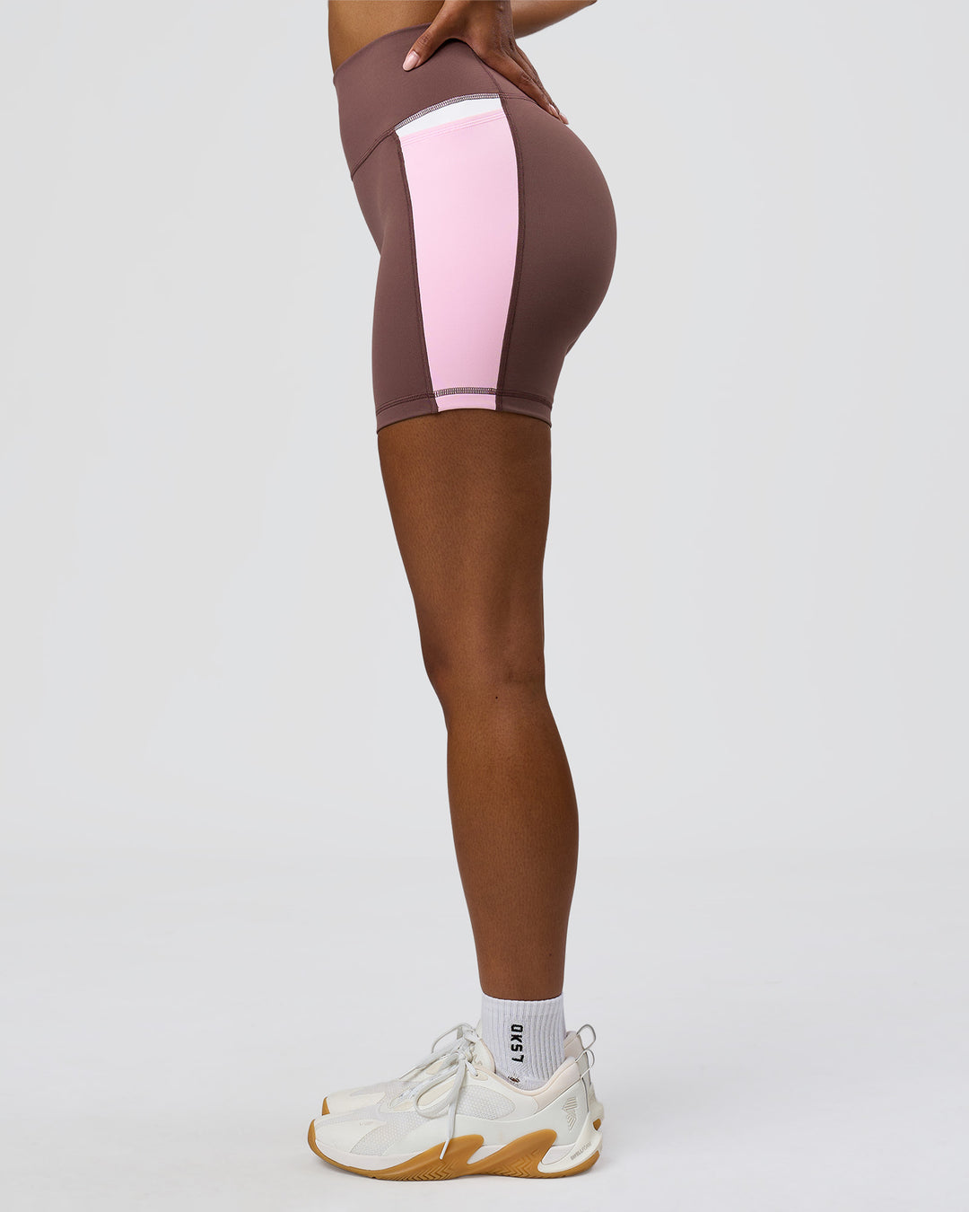 Woman wearing Fusion V-Contour Ultra High-Rise 4" Short Pockets - Cocoa Powder-Marshmallow-White | Model:Jordan | Size:S - view 4