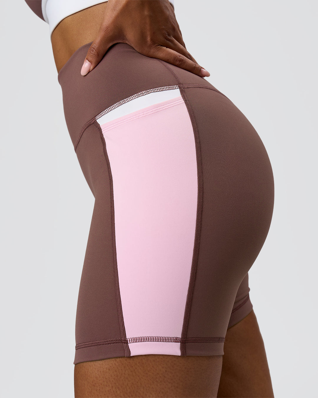 Woman wearing Fusion V-Contour Ultra High-Rise 4" Short Pockets - Cocoa Powder-Marshmallow-White | Model:Jordan | Size:S - view 6