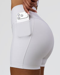 Woman wearing Fusion V-Contour Ultra High-Rise 4" Short Pockets - White | Model:Jordan | Size:S | Thumbnail Index: 1
