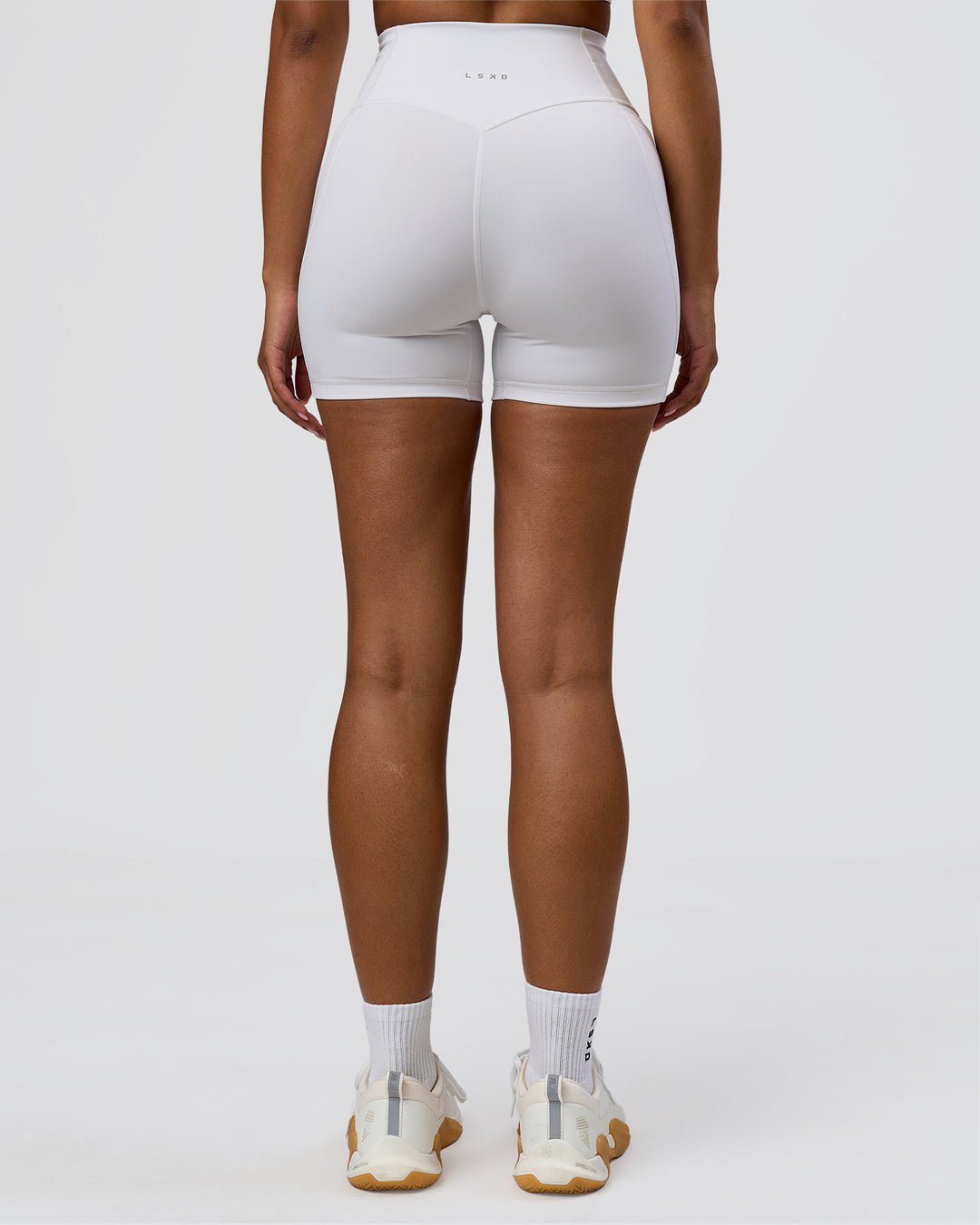 Woman wearing Fusion V-Contour Ultra High-Rise 4" Short Pockets - White | Model:Jordan | Size:S - view 5
