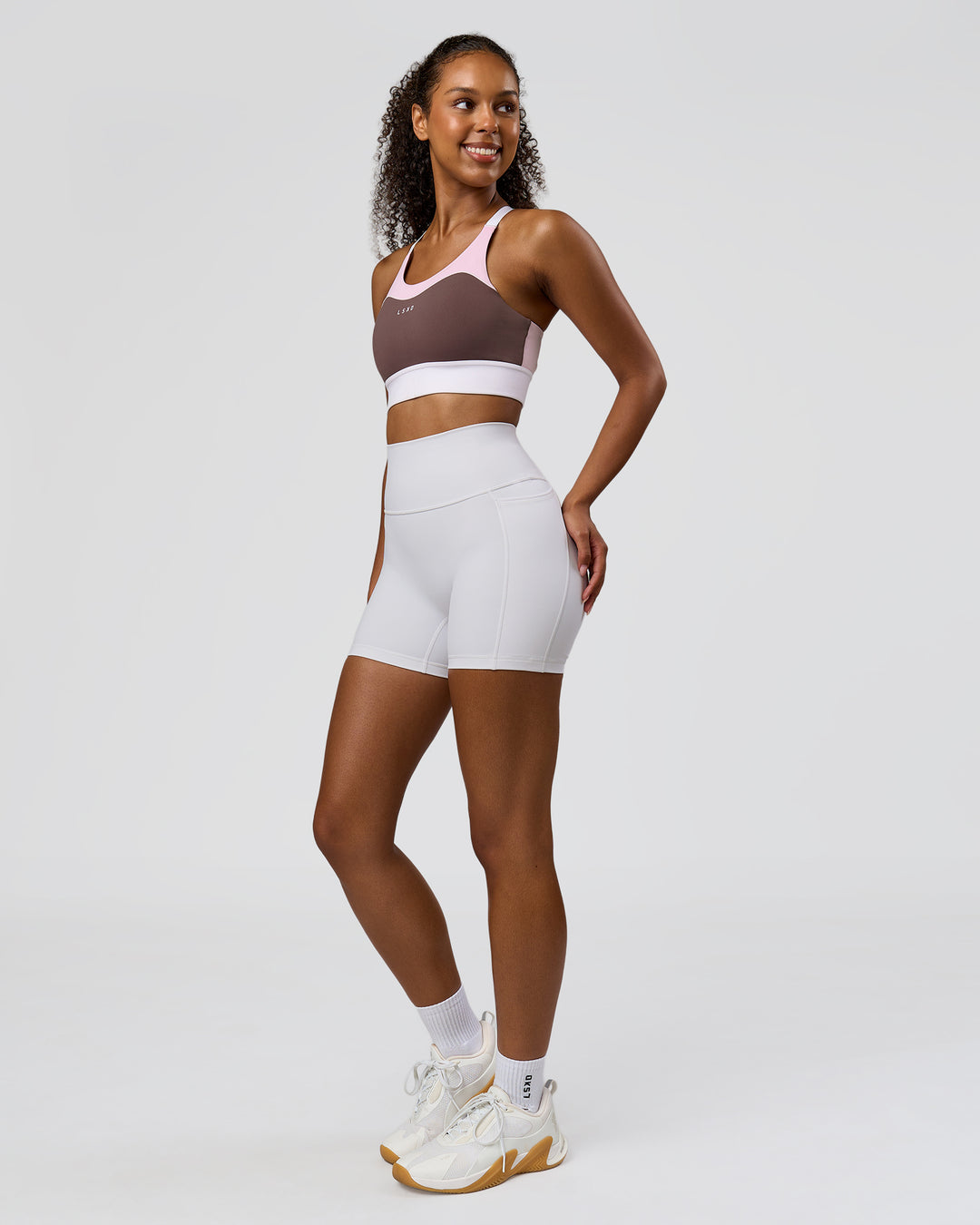 Woman wearing Fusion V-Contour Ultra High-Rise 4" Short Pockets - White | Model:Jordan | Size:S - view 7