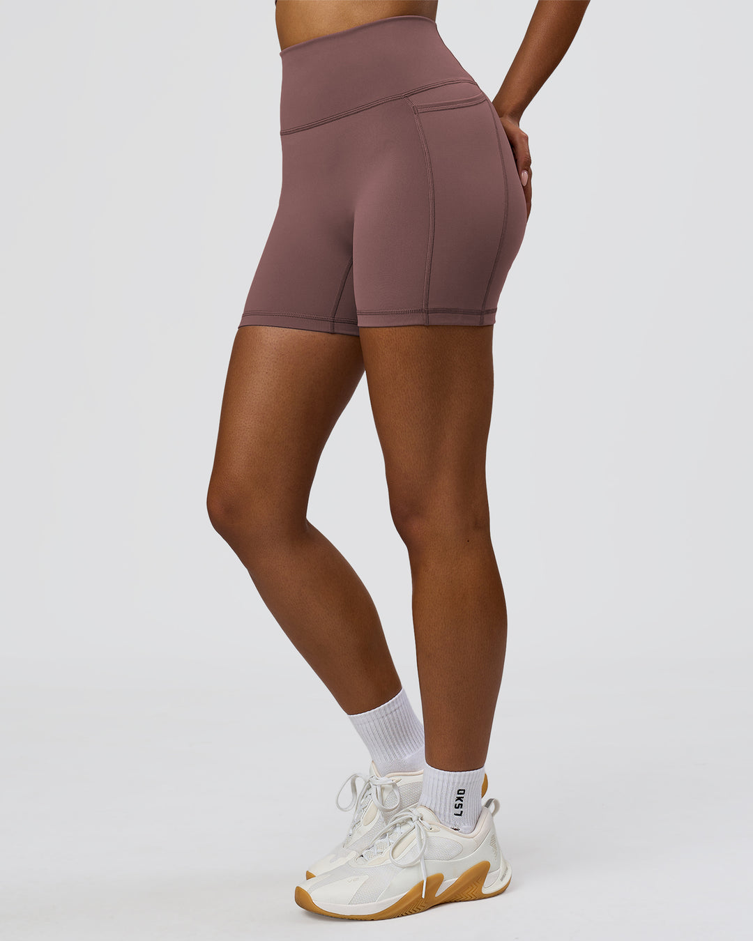 Woman wearing Fusion V-Contour Ultra High-Rise 6" Short Pockets - Cocoa Powder | Model:Jordan | Size:S - view 4