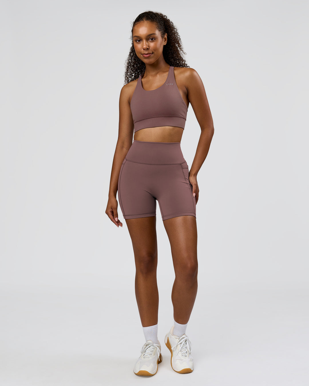 Woman wearing Fusion V-Contour Ultra High-Rise 6" Short Pockets - Cocoa Powder | Model:Jordan | Size:S - view 7
