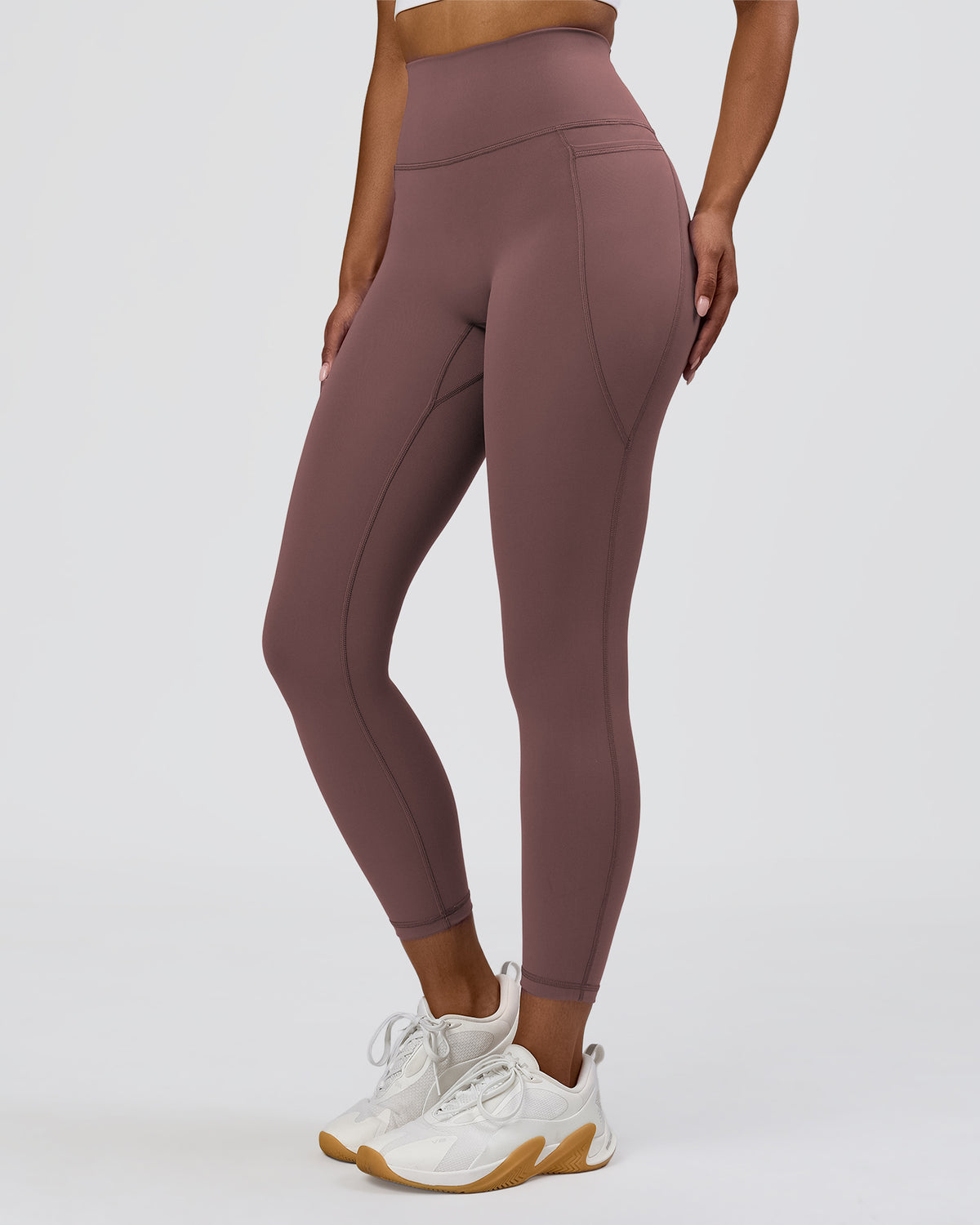 Woman wearing Fusion V-Contour Ultra High-Rise 7/8 Legging Pockets - Cocoa Powder | Model:Jordan | Size:S - view 1