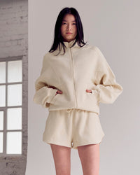 Woman wearing Bree Fleece Track Short - Vanilla Bean | Model:Rianna | Size:S | Thumbnail Index: 1