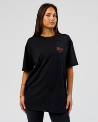 Woman wearing Coffee Run FLXCotton Oversized Tee - Black-Ultra Orange | Model:Bianca | Size:XS | Thumbnail Index: 3