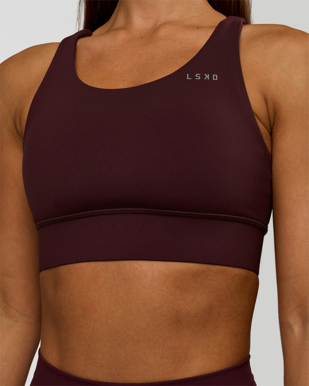 Woman wearing Accelerate Sports Bra - Cherry Lacquer | Model:Brylee | Size:XS - view 1