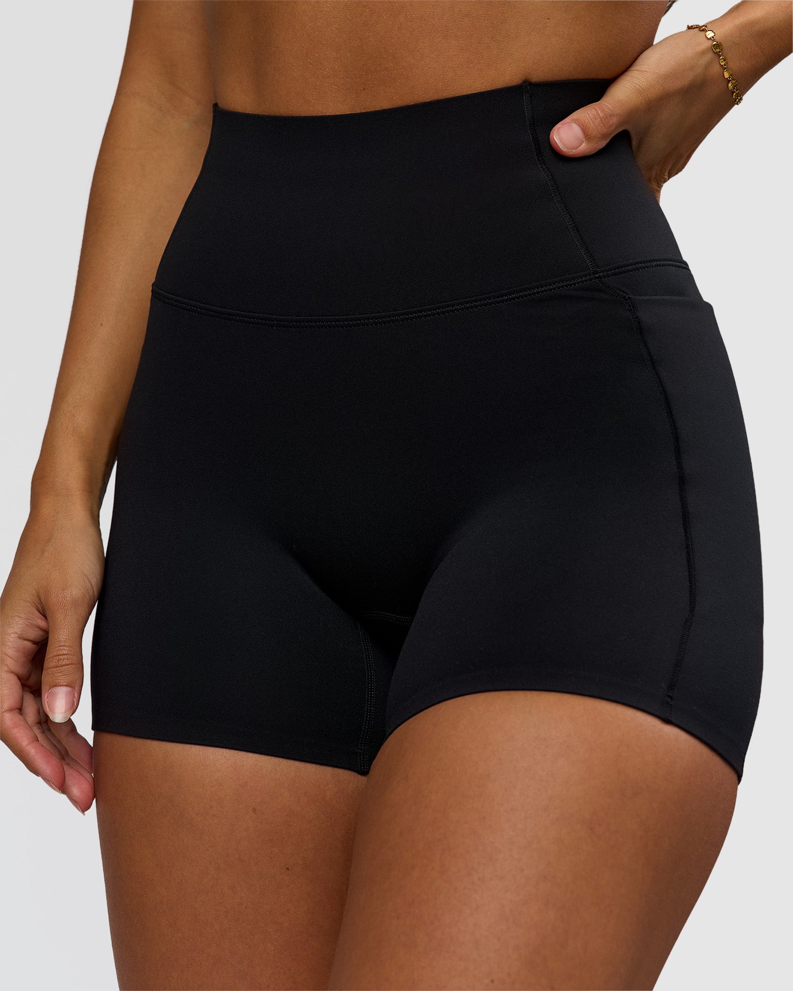 Woman wearing Fusion Bonded High-Rise 4" Short Pockets - Black | Model:Brylee | Size:XS