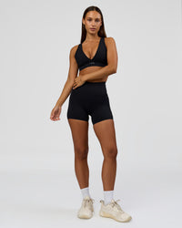 Woman wearing Fusion Bonded High-Rise 4" Short Pockets - Black | Model:Brylee | Size:XS | Thumbnail Index: 3