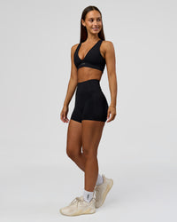 Woman wearing Fusion Bonded High-Rise 4" Short Pockets - Black | Model:Brylee | Size:XS | Thumbnail Index: 4