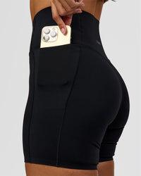 Woman wearing Fusion Bonded High-Rise 6" Short Pockets - Black | Model:Brylee | Size:XS | Thumbnail Index: 1