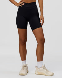 Woman wearing Solstice High-Rise 6" Short - Black | Model:Brylee | Size:XS | Thumbnail Index: 1